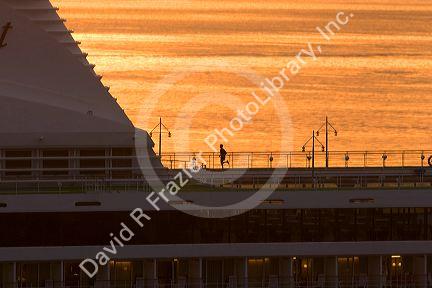 A man jogging at sunrise on the deck of a cruise ship docked in Manaus, Brazil.