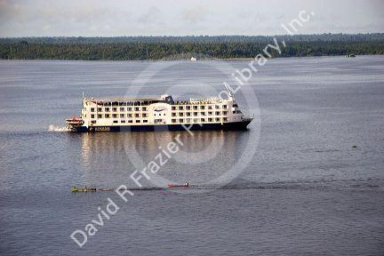 Cruise boat and small river boats on the Amazon at Manaus, Brazil.