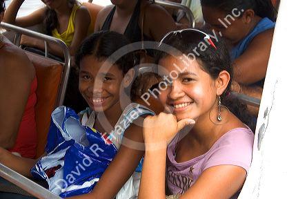 Brazilian girls riding on an Amazon river boat near Manaus, Brazil.