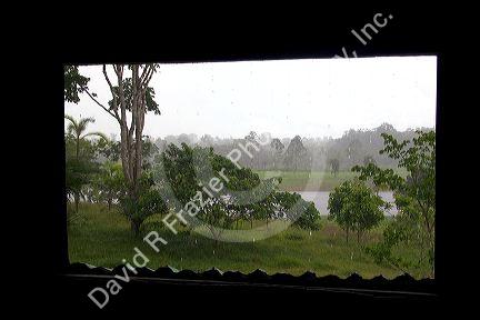 Window frames a view of the rain in the Amazon jungle near Manaus, Brazil.