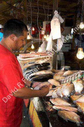 A vendor selling fish at a market in Manaus, Brazil.