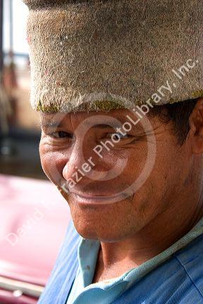 A brazilian porter wearing a wool hat for carrying items on his head in Manaus, Brazil.