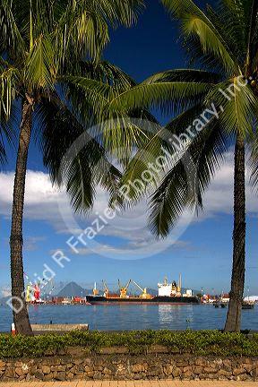 The harbor at Papeete with containers and ships on the island of Tahiti.