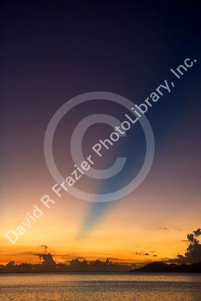 Sunset from the island of Tahiti. The blue band in the sky is believed to be the shadow cast from a mountain on a distant island.