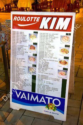 The menu board for a roulotte, food van in Papeete on the island of Tahiti.