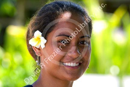Tahitian woman wearing a plumeria flower in her hair on the island of Moorea.