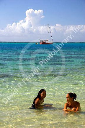 Tahitian women swimming topless in the lagoon on the island of Moorea. MR