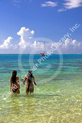 Tahitian women entering the lagoon on the island of Moorea. MR