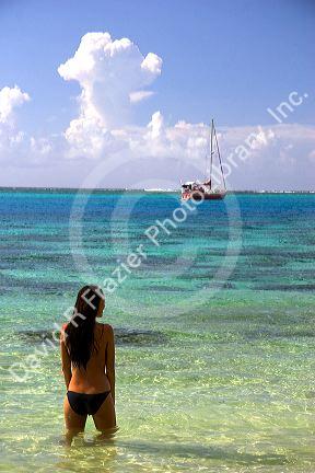 Tahitian woman standing in the lagoon on the island of Moorea. MR