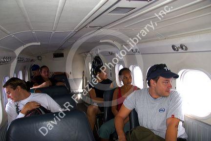 Passengers in a Twin Otter commuter airplane between Moorea and Tahiti in French Polynesia.
