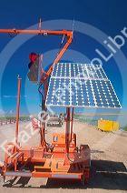 Solar powered portable traffic signal being used at a road construction site.