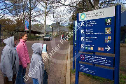 Children reading a sign at the entrance to the Smithsonian National Zoological Park in Washington, D.C.