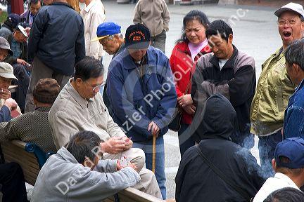 Asian people play a game of cards in Chinatown, San Francisco, California.
