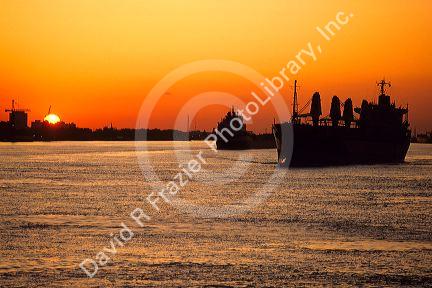 Ships at sunset on the Mississippi River near New Orleans, Louisiana.