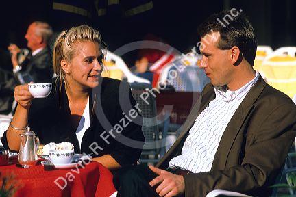 A german couple having coffee at an outdoor cafe.