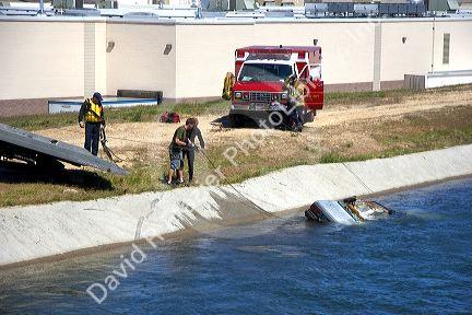 Fire department divers pull a car from a irrigation canal in Boise, Idaho.