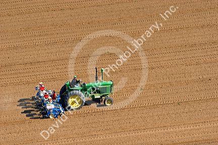 Aerial view of a farmer on a tractor planting seed in Canyon County, Idaho.