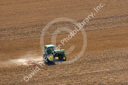 Aerial view of a tractor tilling a field in Canyon County, Idaho.