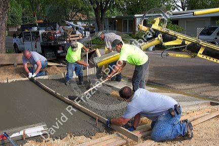 Workers pouring a new concrete driveway in Boise, Idaho.