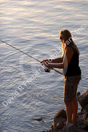 Woman fishing at C.J. Strike Reservior on the Snake River in Idaho.