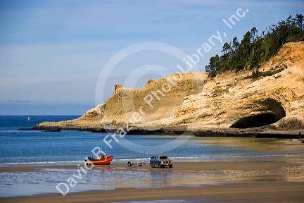 Beach scene with a beached dory boat at Pacific City Point on the Oregon Coast.