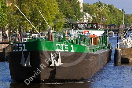 Barge on the Amstel River in Amsterdam, Netherlands.