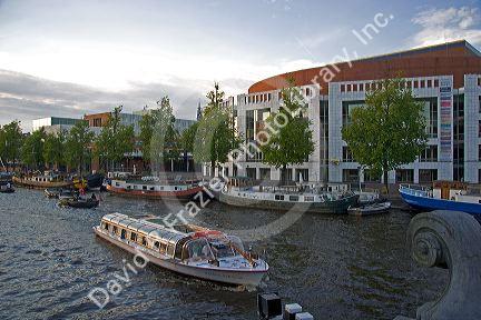 Boating past the Stopera on the Amstel River in Amsterdam, Netherlands.