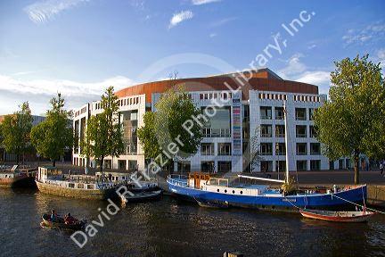 Boating on the Amstel River in front of the Stopera in Amsterdam, Netherlands.