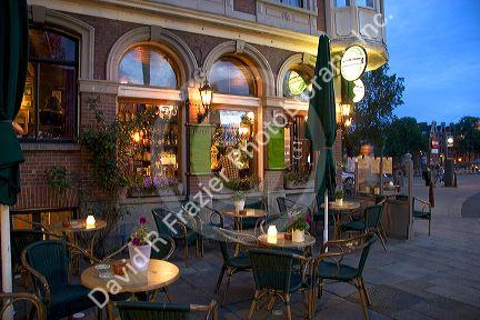 A sidewalk cafe at dusk in Amsterdam, Netherlands.