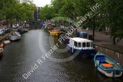 Canal boats docked near the Amstel River in Amsterdam, Netherlands.