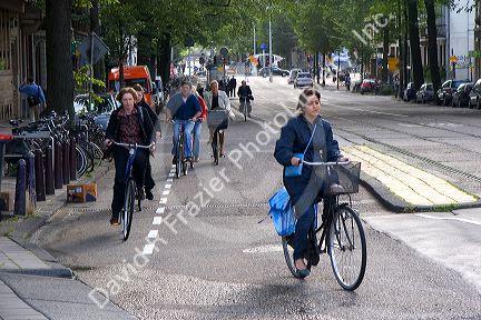 Morning commuters ride bicycles on the streets of Amsterdam, Netherlands.