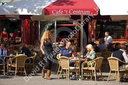 People dine at an outdoor cafe in Amsterdam, Netherlands.