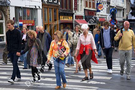 Pedestrians cross the street in Amsterdam, Netherlands.