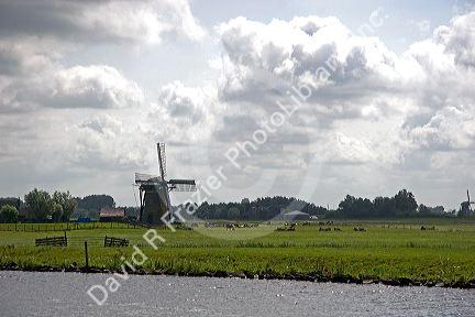 Windmills along a canal east of Leiden in the province of South Holland, Netherlands.