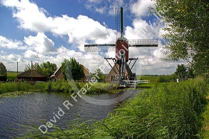 Windmill along a canal east of Leiden in the province of South Holland, Netherlands.