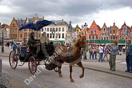 A horse drawn carriage at The Big Market Square in the city of Bruges in the province of West Flanders, Belgium.