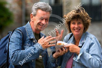 Tourists eat Belgian waffles at Bruges in the province of West Flanders, Belgium.