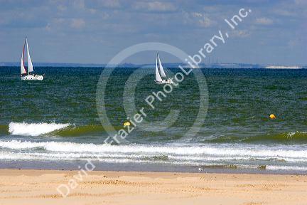 Sailboats in the Strait of Dover in the English Channel at Calais in the department of Pas-de-Calais, France.