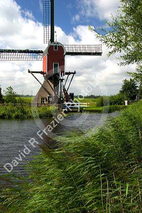 Windmill along a canal east of Leiden in the province of South Holland, Netherlands.