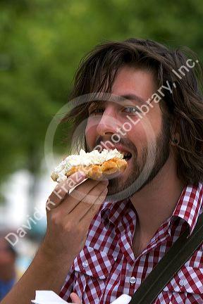 Tourist eating a belgian waffle at Bruges in the province of West Flanders, Belgium.