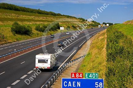 Autos travel on the motorway A84 southwest of Caen in the region of Basse-Normandie, France.