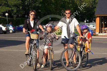 French family on bicycles near Le Mont Saint Michel in the region of Basse-Normandie, France.