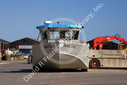 Amphibious boat used for havesting mussels from the bay along the emerald coast near Saint-Martin-du-Viver in the region of Haute-Normandie, France.