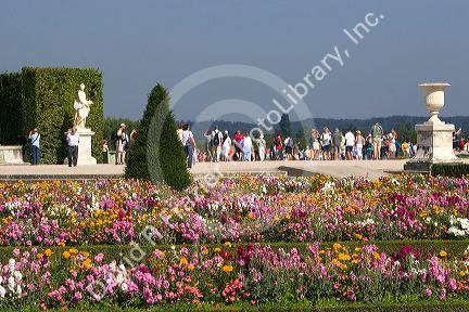 Tourists visit the formal gardens of The Palace of Versailles at Versailles in the department of Yvelines, France.
