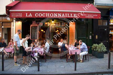 People dine outdoors at a cafe in Paris, France.