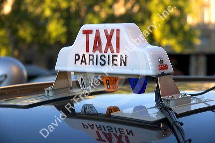 Sign atop a taxi in Paris, France.