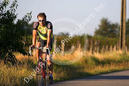 Bicyclist on a rural road in northern Belgium.
