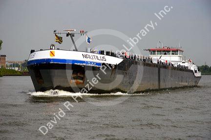 A barge on the Nieuwe Maas river at Rotterdam, Netherlands.