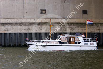 A pleasure boat on the Nieuwe Maas river at Rotterdam, Netherlands.