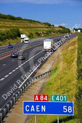 Autos travel on the motorway A84 southwest of Caen in the region of Basse-Normandie, France.